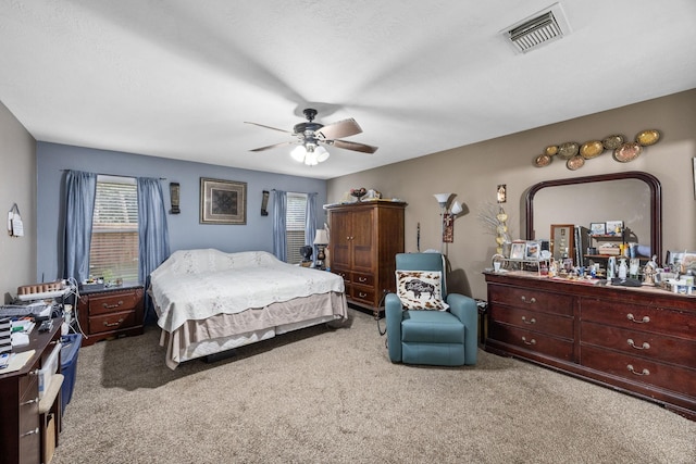 bedroom with light carpet and ceiling fan