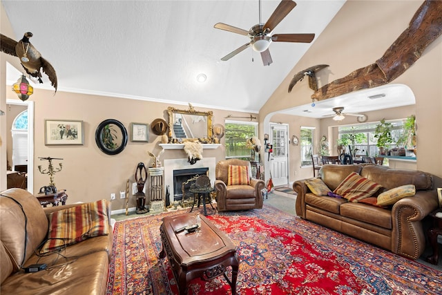 living room with ceiling fan, plenty of natural light, and high vaulted ceiling