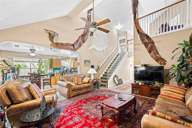 living room featuring ceiling fan and high vaulted ceiling