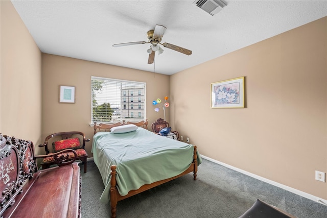 bedroom with carpet, a textured ceiling, and ceiling fan