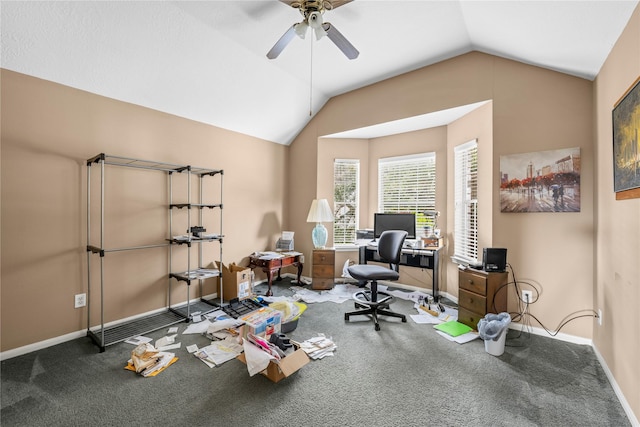 carpeted home office with ceiling fan and vaulted ceiling