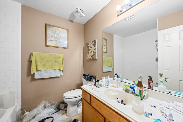 full bathroom with vanity, bathtub / shower combination, a textured ceiling, and toilet