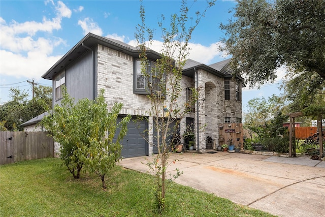 view of front of home with a front yard and a garage