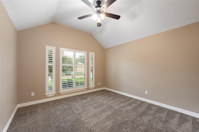 carpeted spare room with ceiling fan and vaulted ceiling