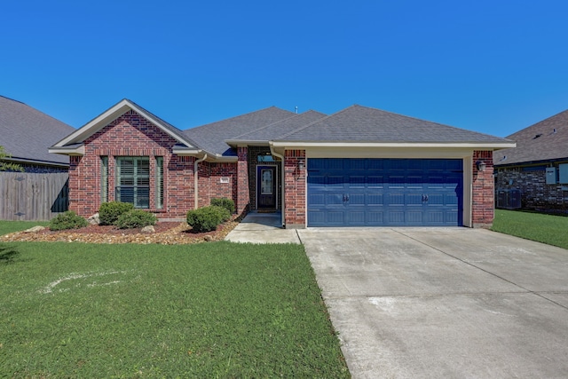 ranch-style house with a garage and a front lawn