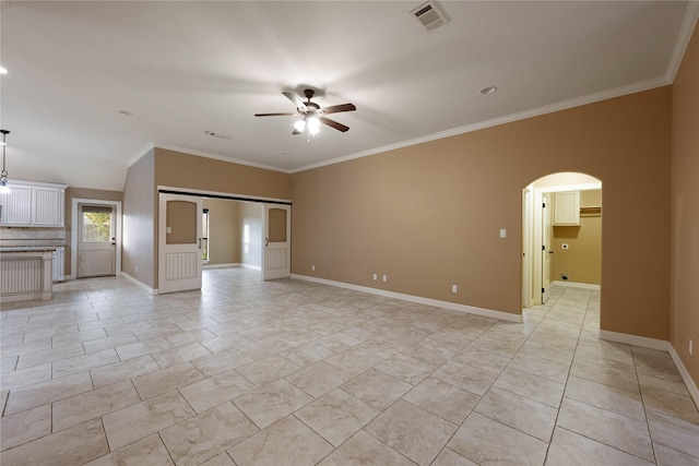 unfurnished living room featuring ceiling fan and crown molding