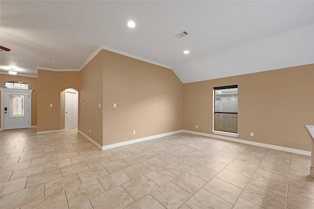 spare room with vaulted ceiling, ceiling fan, and ornamental molding