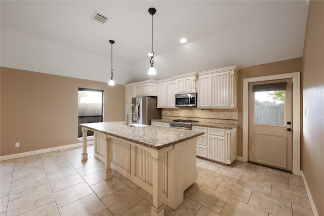 kitchen with pendant lighting, a center island with sink, a breakfast bar area, decorative backsplash, and stainless steel appliances