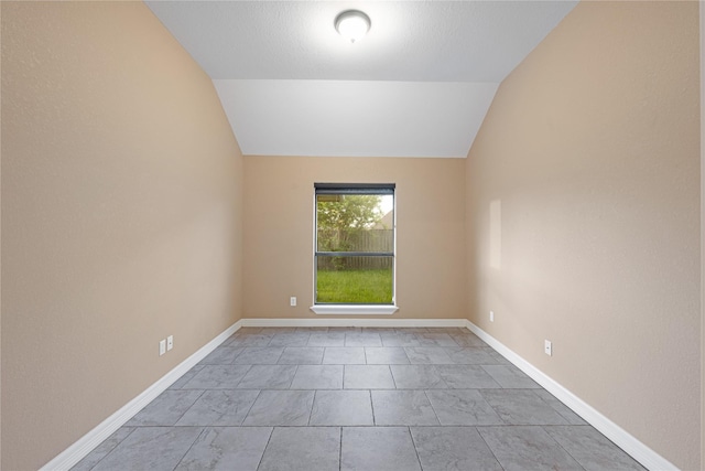 unfurnished room with lofted ceiling