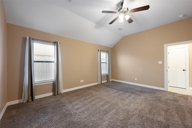 carpeted empty room featuring ceiling fan and lofted ceiling