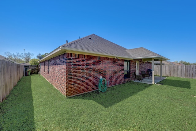 back of property with a yard and a patio