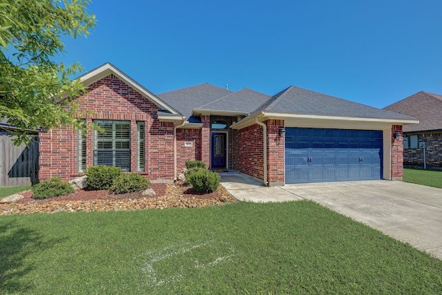 view of front of property featuring a garage and a front lawn