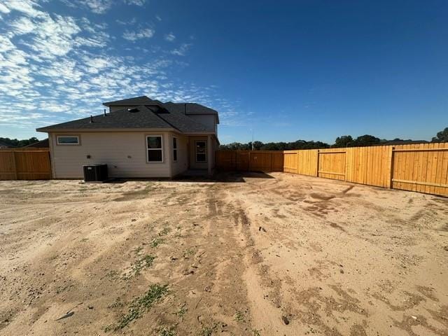 rear view of property with central AC