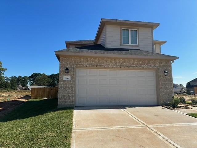 view of front facade with a garage and a front lawn