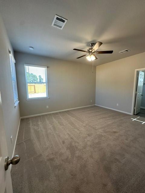 carpeted empty room with ceiling fan