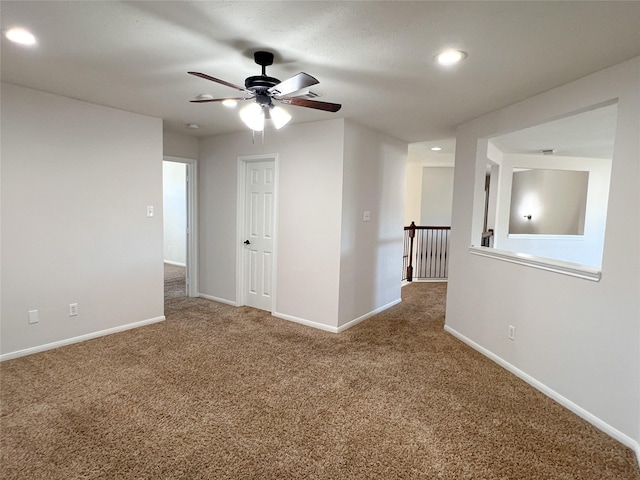 unfurnished room with carpet and ceiling fan