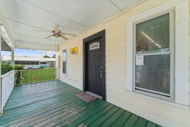 view of exterior entry with covered porch and ceiling fan