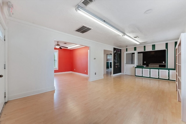 unfurnished living room with a textured ceiling, ceiling fan, light wood-type flooring, and crown molding