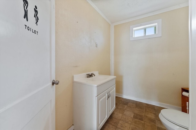 bathroom featuring vanity, toilet, and ornamental molding