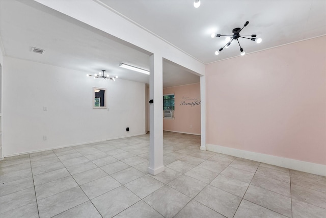 spare room featuring a chandelier, light tile patterned floors, and cooling unit