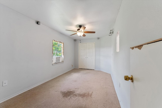 carpeted empty room with ceiling fan and cooling unit