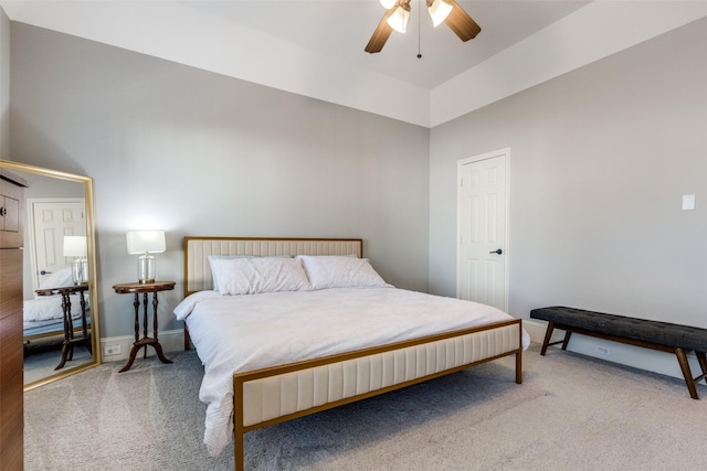 carpeted bedroom with ceiling fan and lofted ceiling