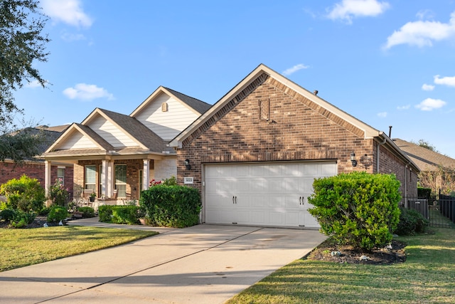 view of front of property featuring a garage and a front lawn