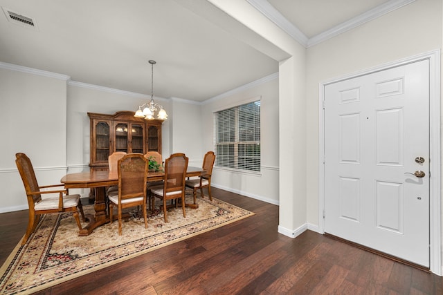 dining space with ornamental molding, dark wood-type flooring, and a chandelier