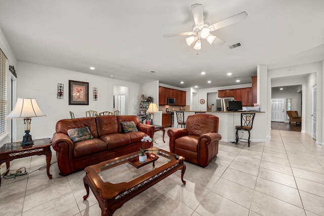 tiled living room with ceiling fan