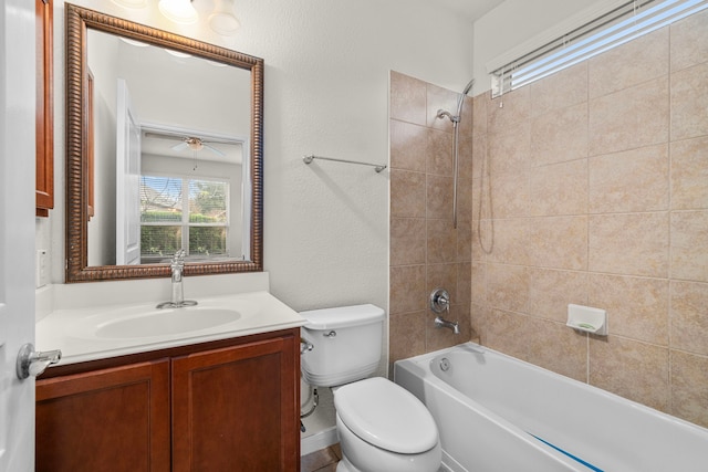 full bathroom with tiled shower / bath, vanity, and toilet