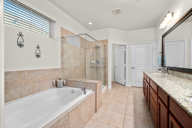 bathroom featuring vanity, tile patterned flooring, and shower with separate bathtub