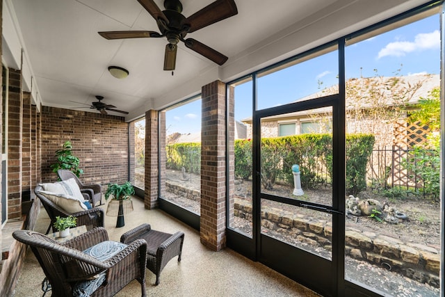 sunroom featuring ceiling fan