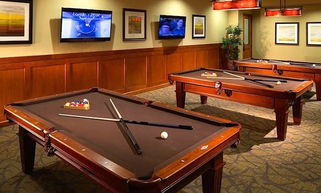 recreation room with pool table, wood walls, and dark carpet