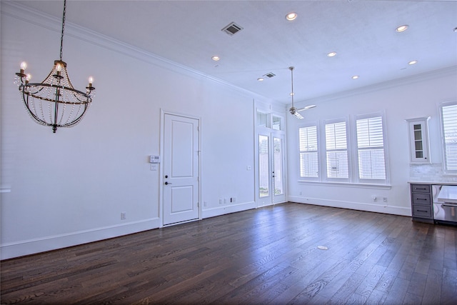 interior space with ceiling fan with notable chandelier, dark hardwood / wood-style floors, and ornamental molding