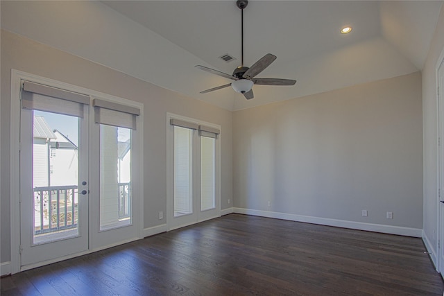 spare room with dark hardwood / wood-style floors, ceiling fan, and lofted ceiling