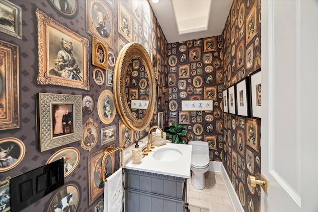 bathroom with tile patterned flooring, vanity, and toilet