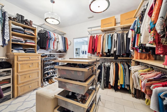 walk in closet featuring light tile patterned flooring