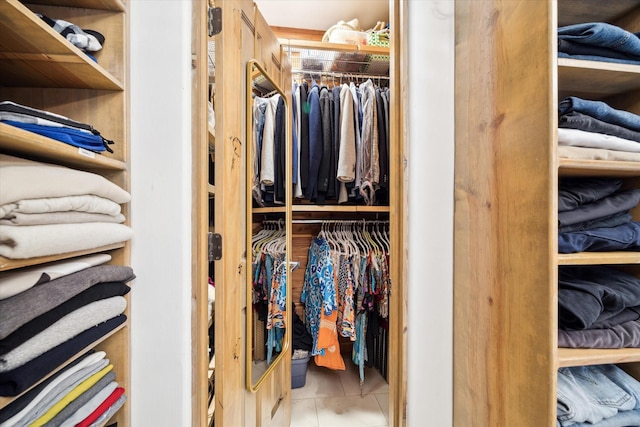 walk in closet featuring light tile patterned flooring