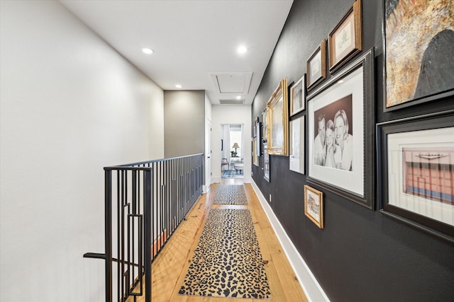 corridor with hardwood / wood-style floors