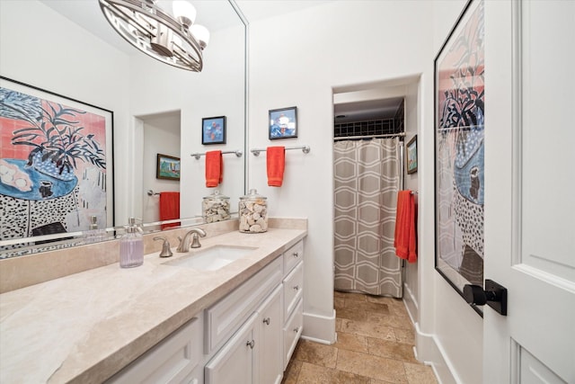 bathroom with a chandelier and vanity