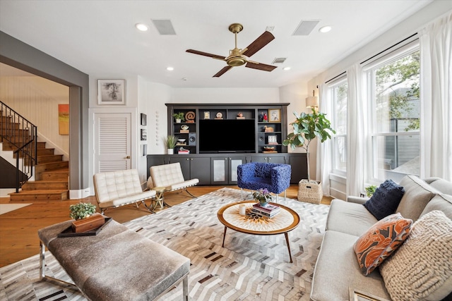 living room with ceiling fan and hardwood / wood-style floors