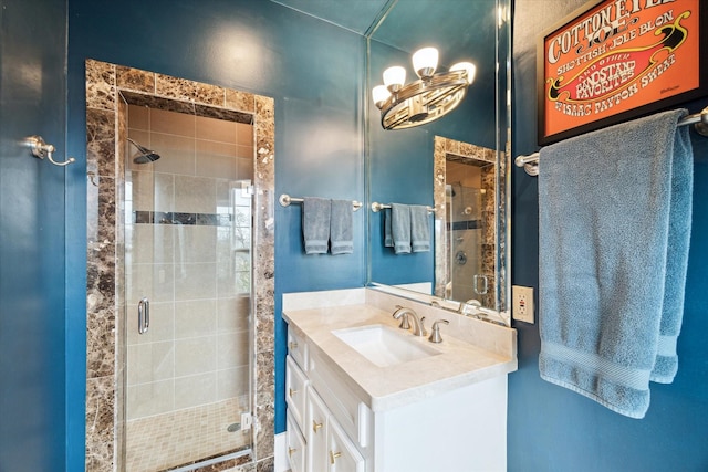 bathroom featuring vanity and a shower with door