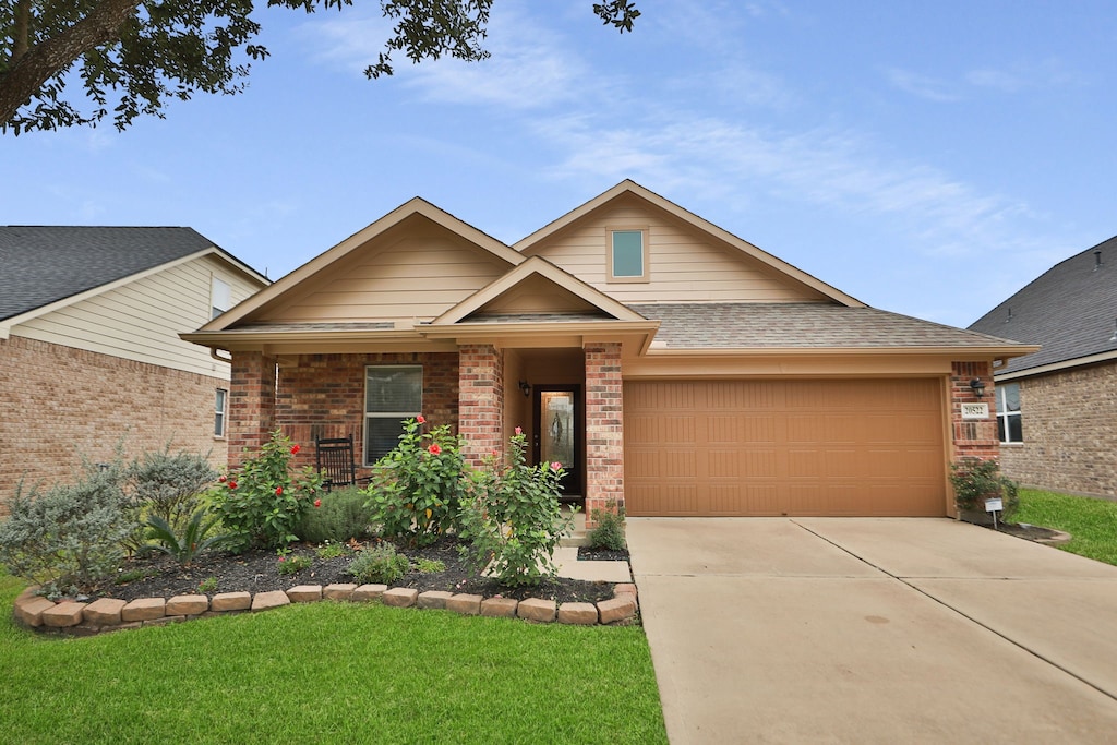 craftsman house featuring a front yard and a garage