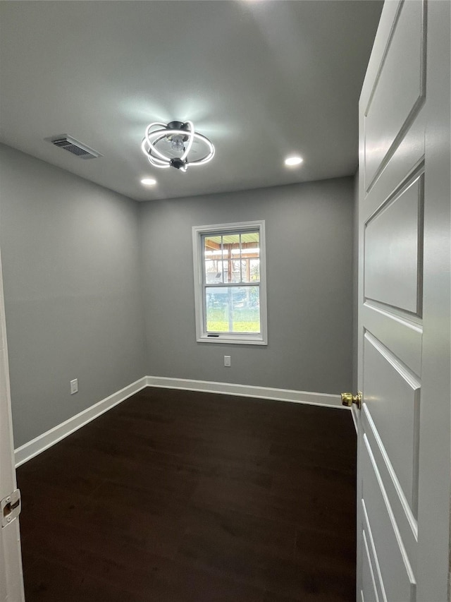 unfurnished room featuring dark hardwood / wood-style flooring