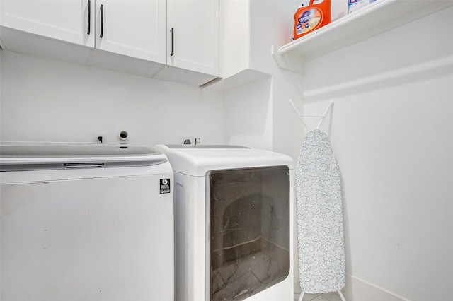 washroom featuring cabinets and independent washer and dryer