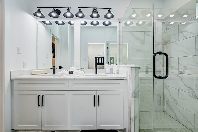 bathroom with vanity and a shower with door