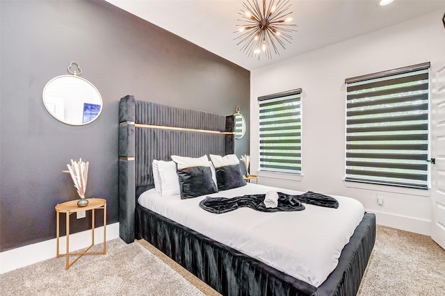 carpeted bedroom with a chandelier