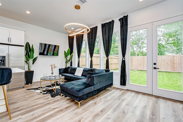 living room with french doors and light hardwood / wood-style floors