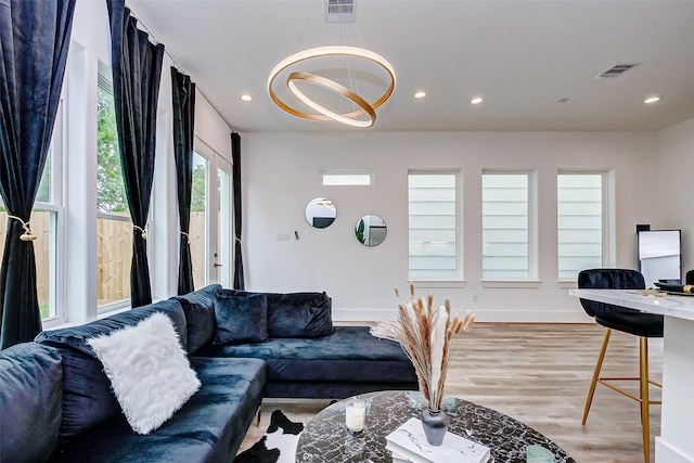 living room with a chandelier and hardwood / wood-style floors