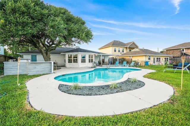 view of swimming pool featuring a yard and a patio area